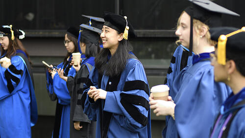 group of Yale Physics graduates in cap and gown at commencement.