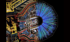 The STAR detector at RHIC with a superimposed image showing particle tracks emerging from a nuclear collision as picked up by the detector. Credit: US Department of Energy