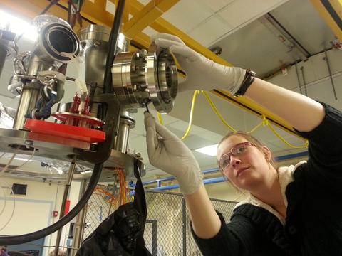 Physics graduate student Lucie Tvrznikova assembles a camera viewport on a liquid argon high voltage test experiment. Photo by Ethan Bernard.