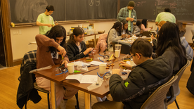 group of people working at a table.