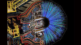 The STAR detector at RHIC with a superimposed image showing particle tracks emerging from a nuclear collision as picked up by the detector. Credit: US Department of Energy