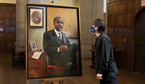 (c) Yale News. Asher Liftin ’21 admiring the new portrait of Edward Bouchet. (Photos: Jessica Smolinski)